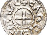une vieille pièce d'argent ornée d'une croix