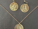 a gold necklace and earring set with a leaf design