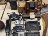 a lot of old cameras and other items on a table