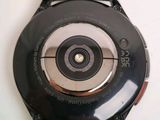 a close up of a watch on a white surface