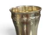 a silver cup that is sitting on a table
