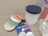 a book, cups, and other items sitting on a table
