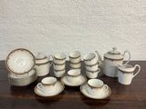 many cups and saucers sitting on a wooden table