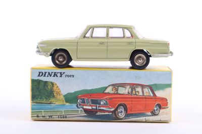 a green toy car sitting on top of a box