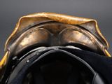 the back end of a horse ' s saddle with a black hat on it