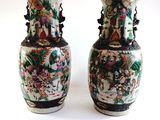 two vases sitting side by side on a white surface