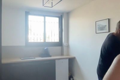 a man that is standing in front of a window