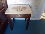 une petite table en bois ornée d'un motif floral