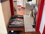 a hallway with a red door and a wooden floor