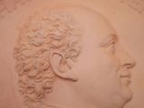 a close up of a sculpture of a man with curly hair