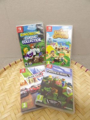 two nintendo wii games sitting on top of a basket on top of a table