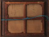 an old wooden window with a blue wire hanging from it ' s side
