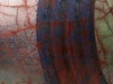 a close up of a vase with a red and blue design