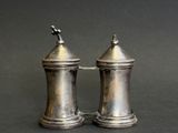 pair of silver salt and pepper shakers on a black background