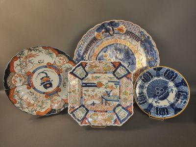three plates with different designs on them sitting on a table