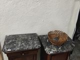 two tables with marble tops and a basket on top of them