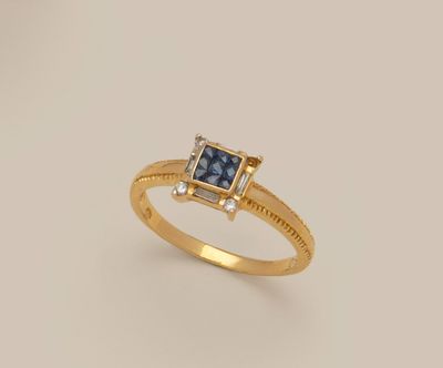 an image of a gold ring with a blue stone and diamonds