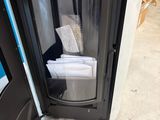 a black and white photo of a door with towels in it