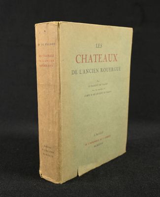 an old book sitting on top of a black table next to a black background