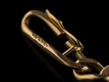 a close up picture of a metal carabine on a black background