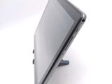 a tablet computer sitting on a stand on a white surface