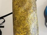 a yellow bag sitting on top of a table next to a computer mouse