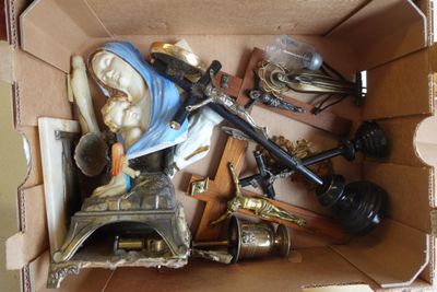 une boîte en carton remplie d'objets divers, dont une statue représentant une femme