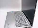 a laptop computer sitting on a table with a keyboard