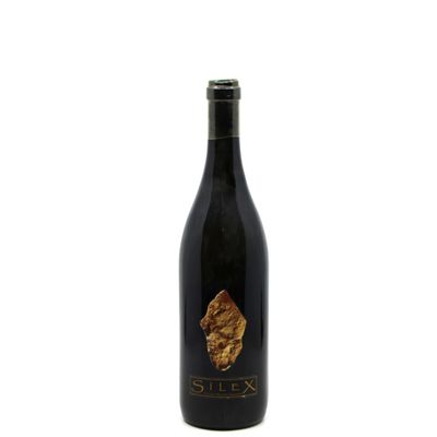 a bottle of wine sitting on top of a white surface