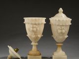 a pair of carved ivory vases with handles and a lid