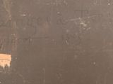 graffiti on the wall of a bathroom with a toilet and a toilet paper dispenser