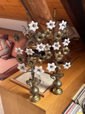 two vases with flowers on a table in a living room