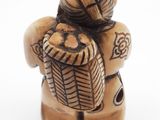 a small figurine of a man holding a basket