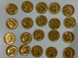 a lot of gold coins sitting on a white surface