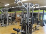 a gym with a lot of equipment in the room