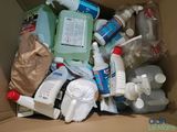 a cardboard box filled with bottles and containers of cleaning products