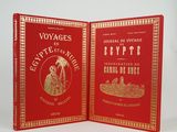 two red book covers with gold trimming and gold trimming on them