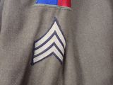 a close up of a military uniform with a blue and red stripe on it
