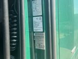 a close up of a green truck door with a phone on it