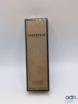 a bottle of lagerfield perfume sitting on a white surface