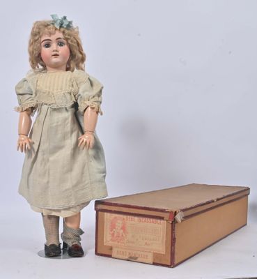 a doll that is standing next to a box