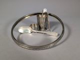 a silver tray with spoons and a cup on it