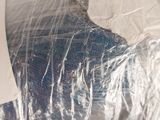 a piece of plastic wrapped in plastic and a pair of scissors on a table