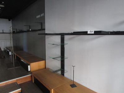 a long wooden bench in a room with a mirror on the wall