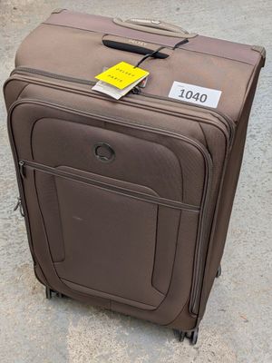 a piece of luggage sitting on the ground with a price tag attached to it