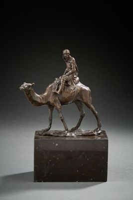 bronze statue of a man riding a camel on a marble base
