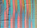 a close up of a multicolored scarf on a table