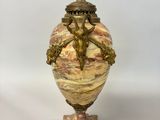 a vase that is sitting on a stand on a table