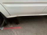 a white car with a flat tire on the street