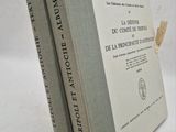 two books sitting on top of each other on a white surface